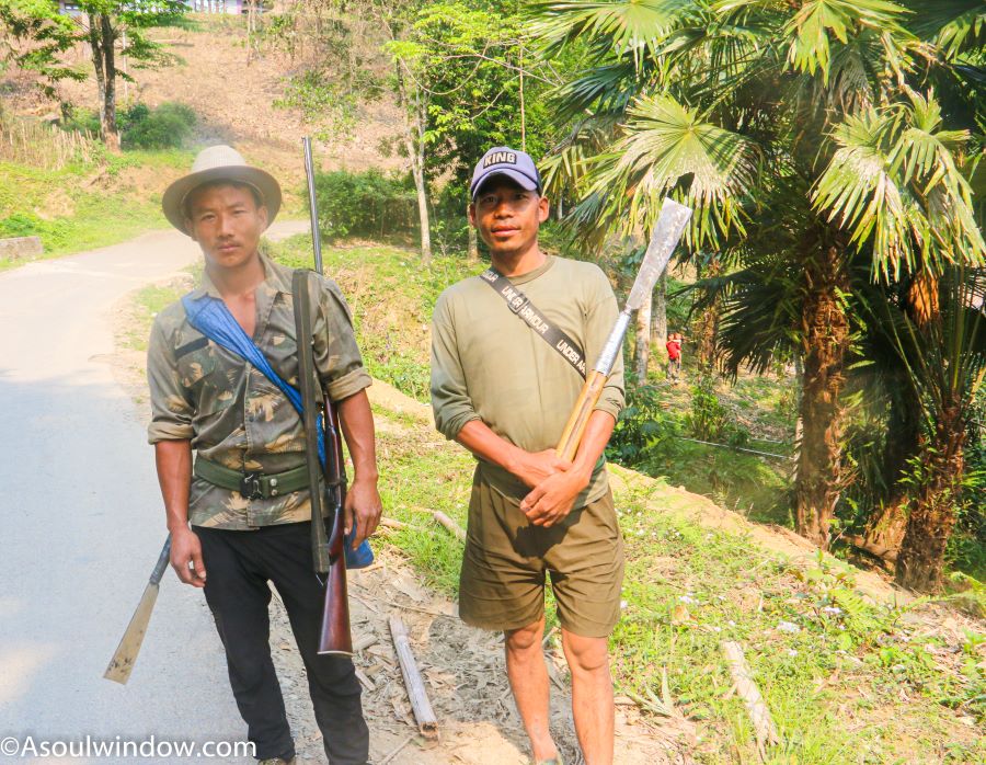 Local Wancho men carrying dhau and rifles. On my way to Konsa from Longding. 