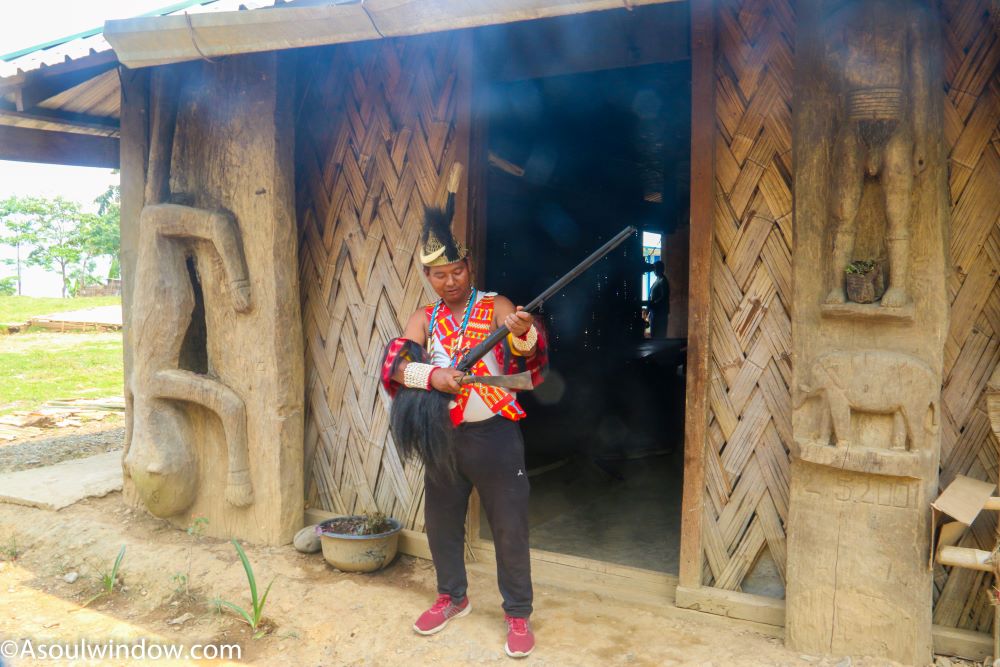 Wancho man in traditional dress at the home of King of Nyinu village. Arunachal Pradesh